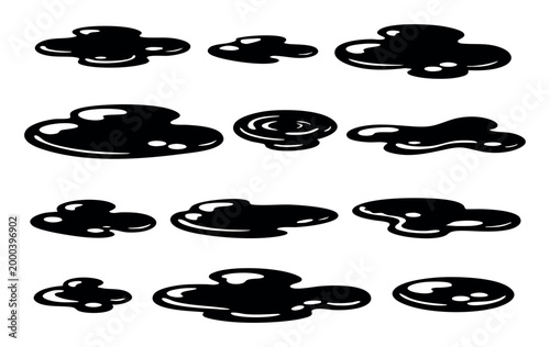Black liquid or oil puddles and spills in various shapes and sizes, appearing as sticky blobs, drops, and stains