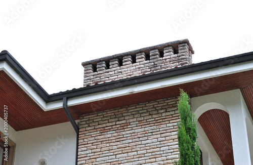 Modern Traditional Chimneys on New Italian House seen from Below 