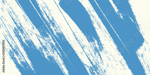 Abstract creative background displaying rough diagonal brush strokes in blue paint on an off-white textured surface