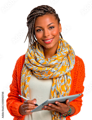 Young creative woman with braids and an orange cardigan holding a tablet and stylus