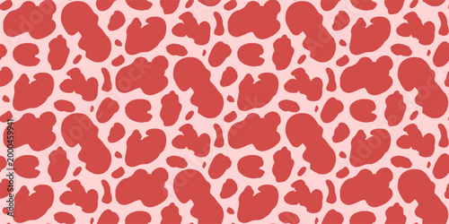 Spot abstract organic seamless pattern in red on pink background. Bold freeform blob and splotch as animal vector for fashion textile. Girly coquette animalistic motif in monochrome scattered repeat.