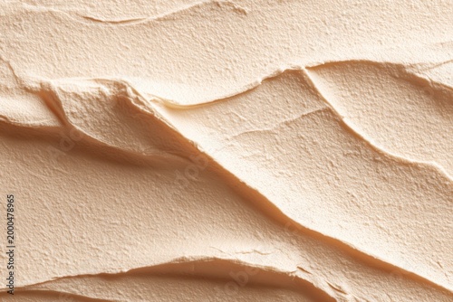 Crafting beauty with deep beige cream texture in artistic skincare design