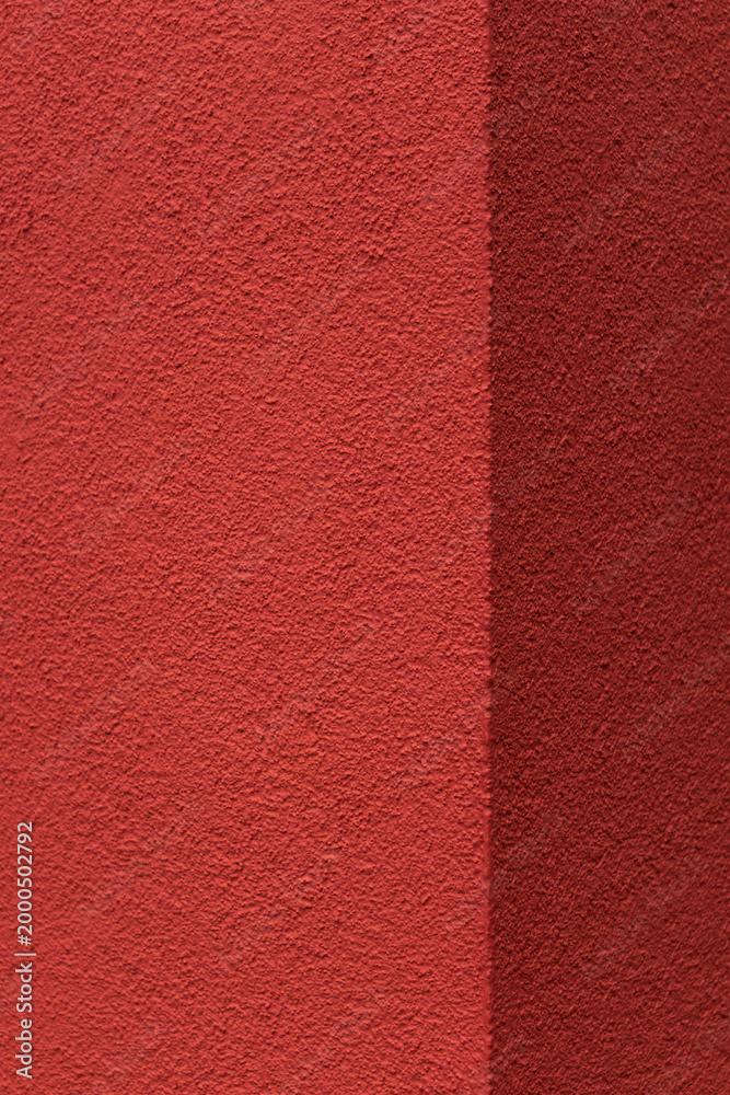 Fototapeta premium Red stucco wall split with vertical edge
