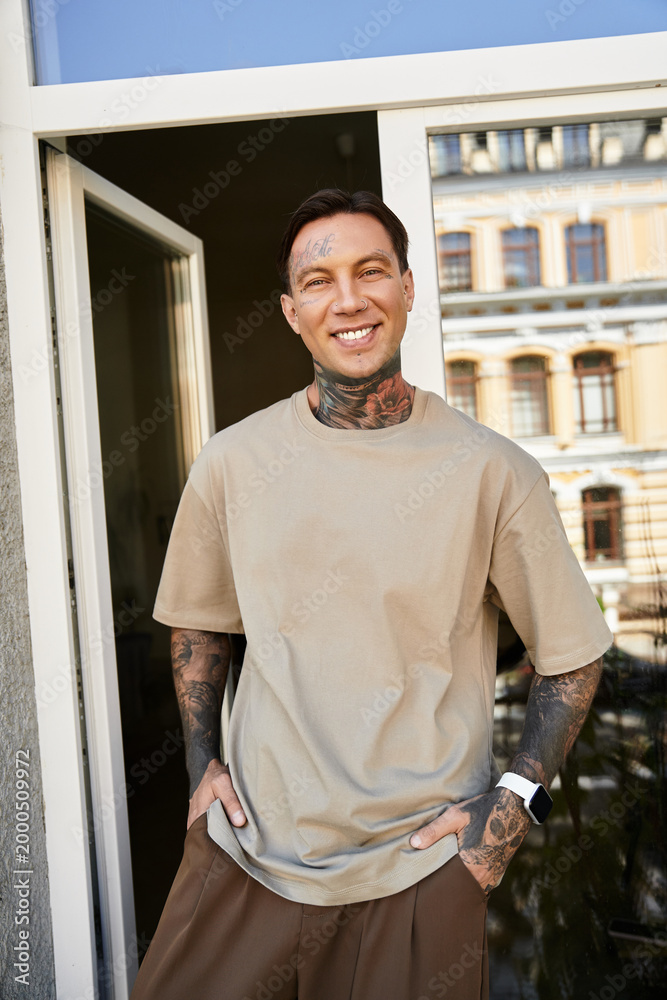 Fototapeta premium Young man enjoys a sunny day at home, showcasing his style and confidence