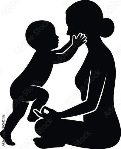 Black silhouette of a mother sitting in a yoga pose while her baby touches her face depicting a peaceful moment of mindfulness and maternal affection at home