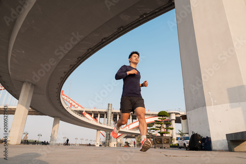 Dynamic Shot of Man Run Urban Environment Under Bridge Arch Structure