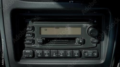 Inserting a CD Into the Factory Retro CD Cassette Radio Deck Mounted on the Car Dashboard, Playing It, and Then Pressing the Eject Button to Remove It