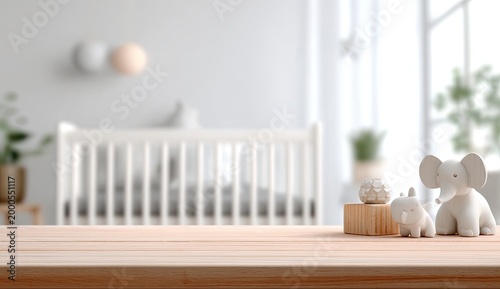 A serene nursery scene features wooden elephant toys on a light wood surface with a blurred crib in the background.