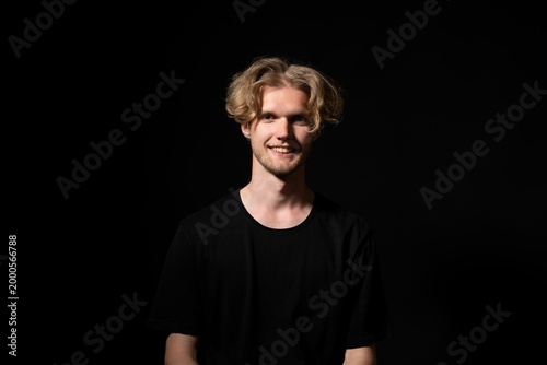 Photography Young blonde man smiling, expressing happiness and confidence in a studio portra