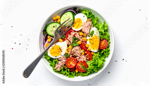 Tuna salad with egg, vegetables and corn in a white bowl