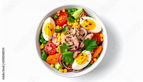 Tuna salad with egg, vegetables and corn in a white bowl