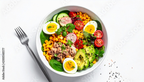 Tuna salad with egg, vegetables and corn in a white bowl