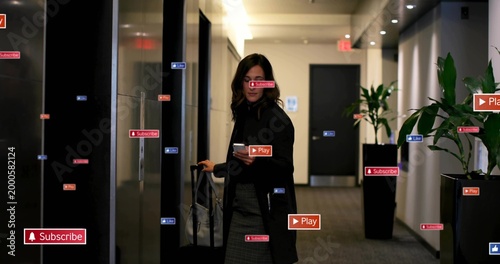 Holding phone, guest wearing dark coat in hotel hall, rolling suitcase, tote, floating UI labels