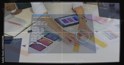 Pointing three women in business attire reviewing mockups and swatches in office, with tablets HUD