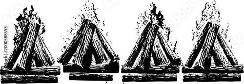 four campfires burning brightly on wooden logs with visible flames and smoke