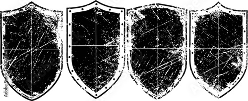 set of four vintage distressed shield silhouettes with various scratch textures and grunge effect
