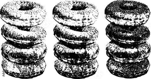Stack of plain bagels arranged in three vertical piles on white background