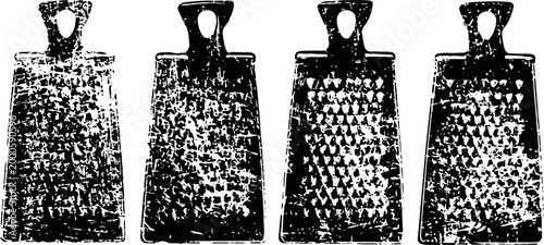 Four antique metal cowbells with rustic texture and loop handles in a row