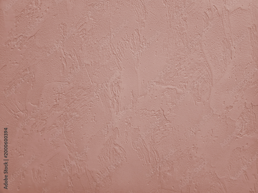 Fototapeta premium Blush pink decorative plaster wall with vertical drip relief texture, background with organic fine-grained relief pattern