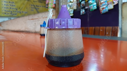 small bottle containing soy sauce