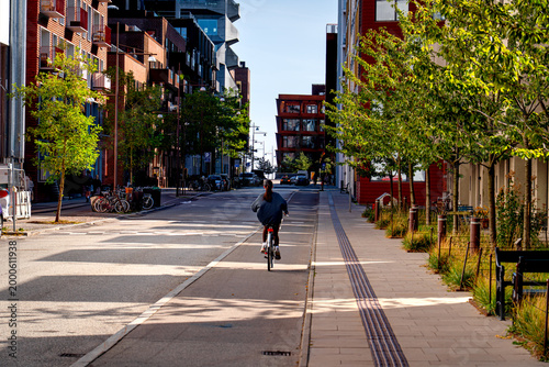People on bikes in Nordhavn district Copenhagen on sunny day, life in Denmark.