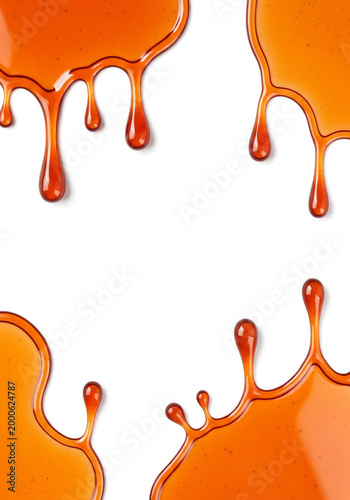 Honey or maple syrup drips isolated on white background
