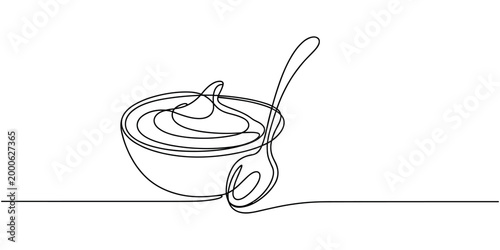 Single line of cream in a bowl with a spoon food dessert
