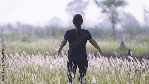 Woman Practicing Yoga in Serene Open Field of Tall Grass