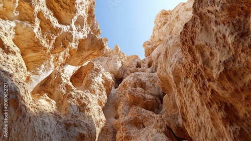 Cinematic 3d desert canyon with steep stone walls and narrow paths bathed in warm rusty colors