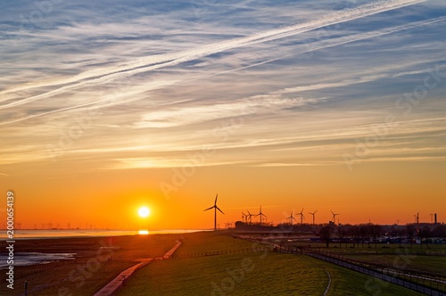Distant view of wind turbines along the river Ems, East Frisia, Lower Saxony, Germany
