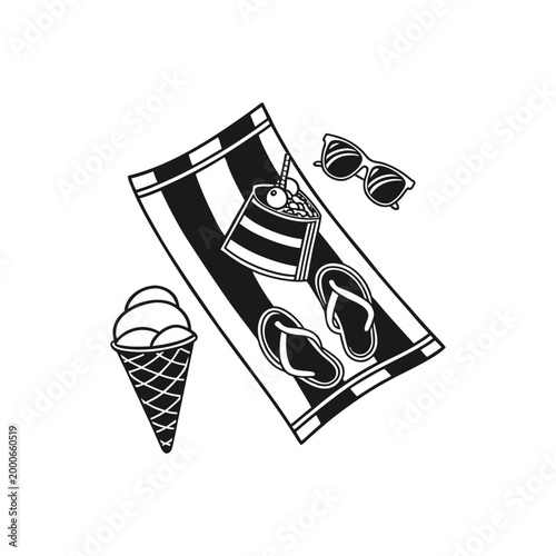 Black and white beach towel with flip flops and ice cream