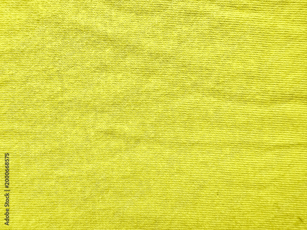 Fototapeta premium vibrant yellow corduroy fabric texture closeup showcasing fine parallel ridges and soft velvety surface in warm golden hues