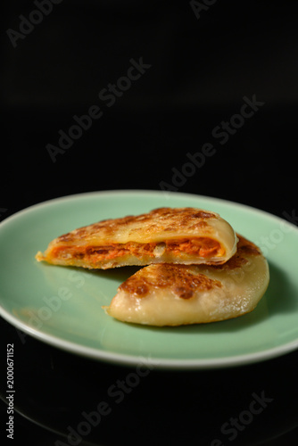The delicious Orleans chicken pancake on the plate on the table