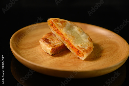 The delicious Orleans chicken pancake on the plate on the table