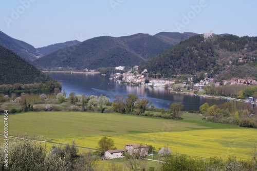 Photos woods, hills and agricultural areas surround the lake and the village of Piedilu