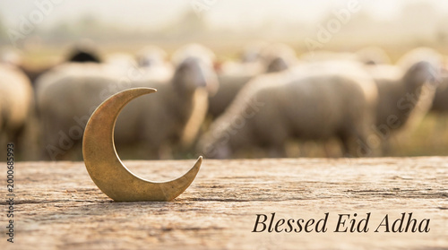 Elegant eid mubarak composition with focus on crescent and soft blurred sheep in background
