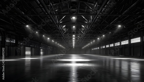 Industrial warehouse interior with dark metal structure and bright spotlights reflecting on polished concrete floor creating dramatic atmosphere for logistics distribution center and storage