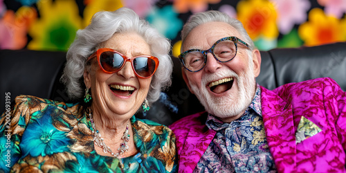Joyful senior couple smiles radiantly, wearing stylish glasses and vibrant clothing