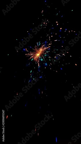 A Captivating Display of Colorful Sparks: Witness the Dynamic Explosion of Light and Energy in a Nighttime Firework Show, Creating a Dazzling Visual Experience