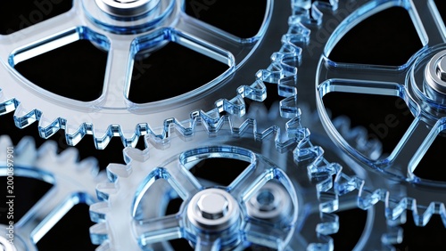 Foto Close-up of transparent blue gears interlocking against a black background