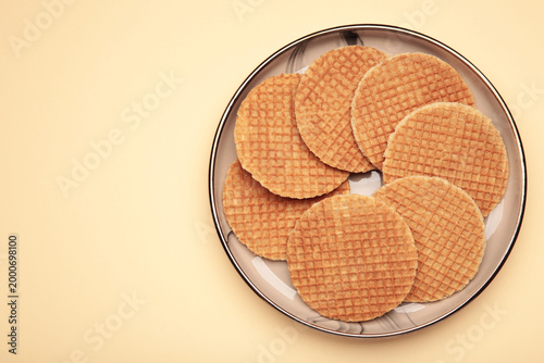 Dutch waffles stroopwafel syrup waffle caramel waffle on plate on beige background. Space for text
