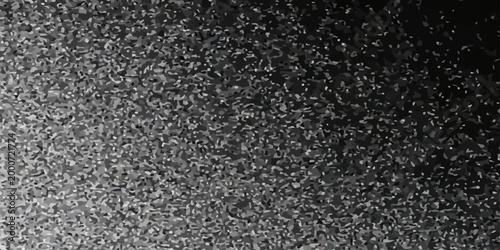 A dark closeup of a rough black asphalt texture showing the detailed stone pattern of a tarmac road surface