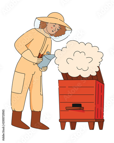 Woman beekeeper in protective suit holding fumigating bee hive with smoke