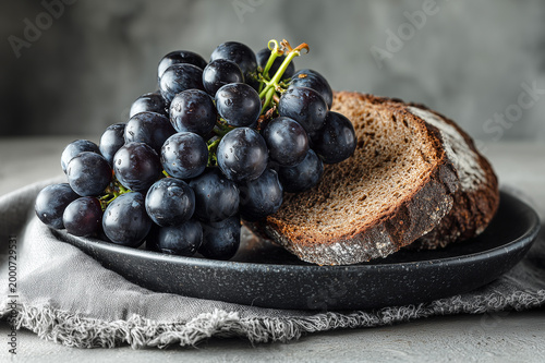Close-up of grapes and homemade bread. Farm-to-table and authentic living concept. Simple food and mindful lifestyle.