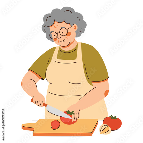 Elderly woman in apron slicing red tomato with knife on wooden board