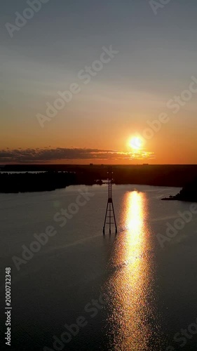 Scenic sunset at Hietaniemi Beach (Hietsun ranta) in Helsinki, Finland. Soft waves, golden sky, and tranquil seaside mood captured during a summer evening.