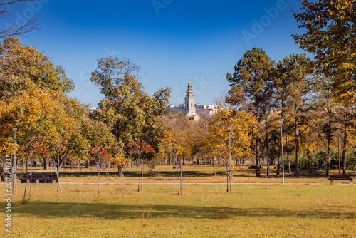 Colorful autumn trees filling Usce park with the Church spire in the background, Belgrade