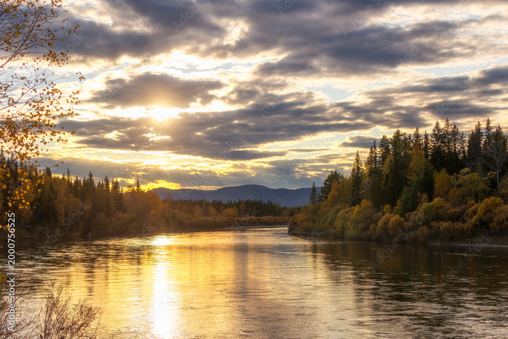 Fototapeta premium An autumn sunset on the Selenga River, which flows into Lake Baikal. Russia