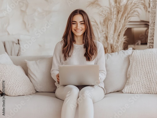 Young woman using laptop in cozy living room with natural light