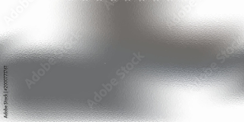 Shiny silver foil metallic texture - glossy gray steel gleaming surface, frosted glass effect with blur glare reflection, bright polished metal material. Brushed aluminum or chrome glistening bg.